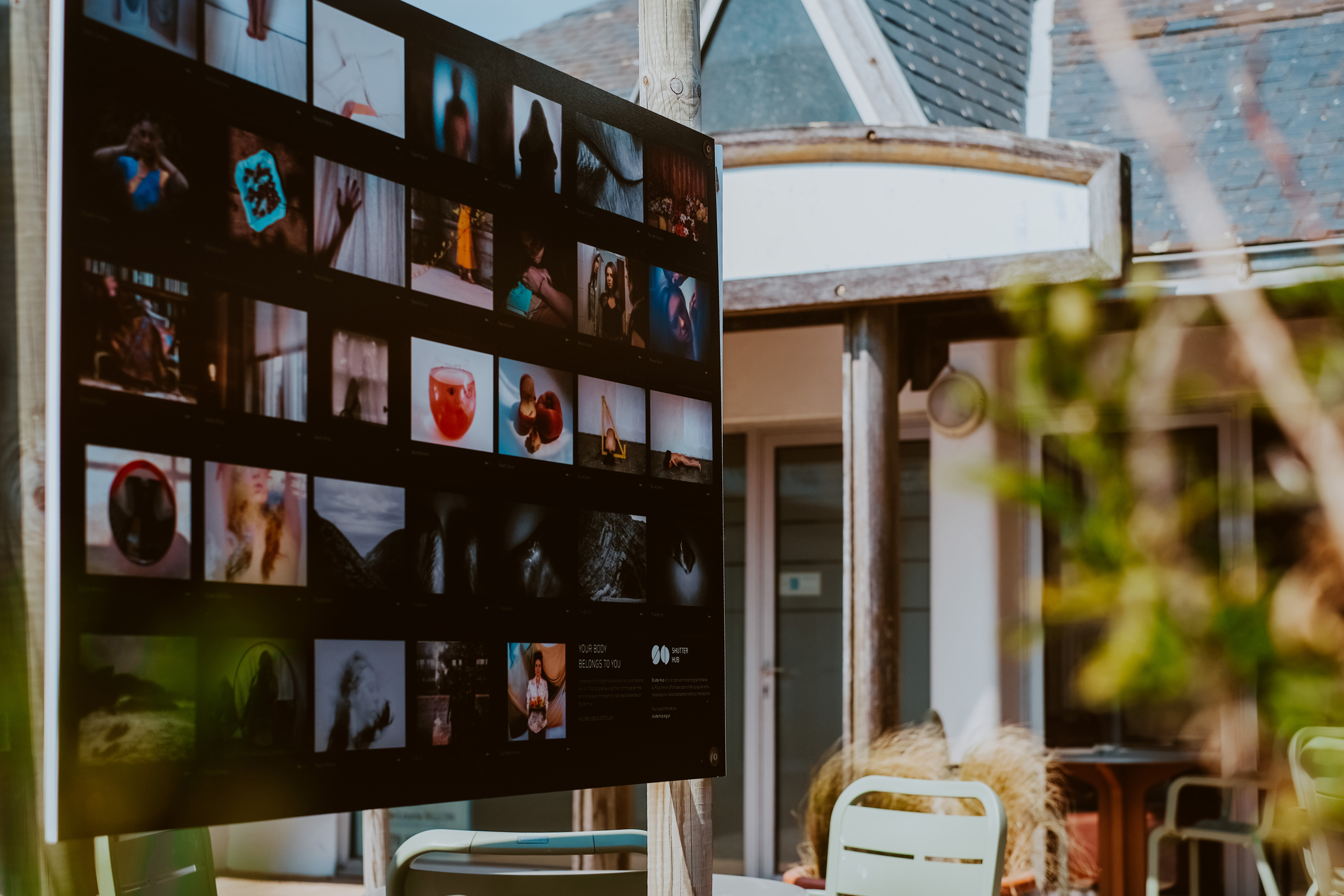 photograph of an exhibition panel board displaying photographs in an outside space