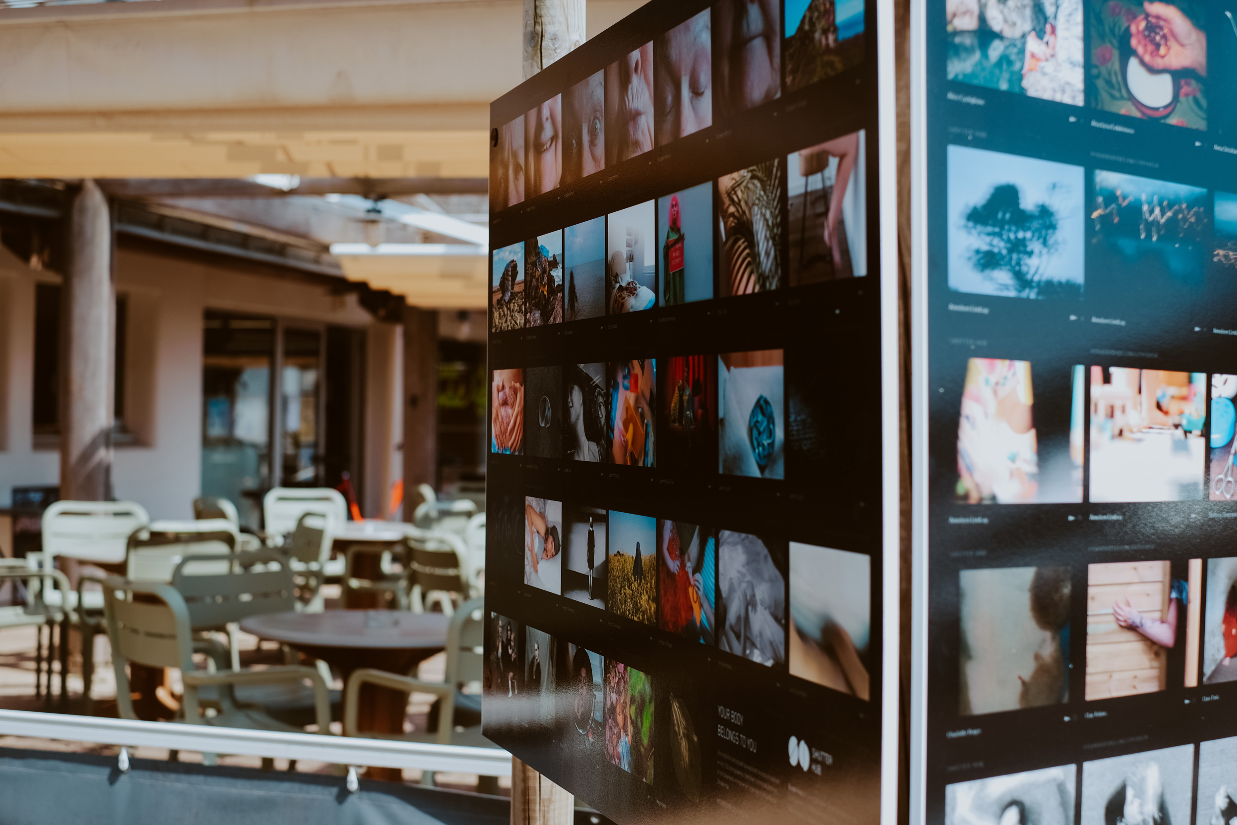 photograph of an exhibition panel board displaying photographs in an outside space