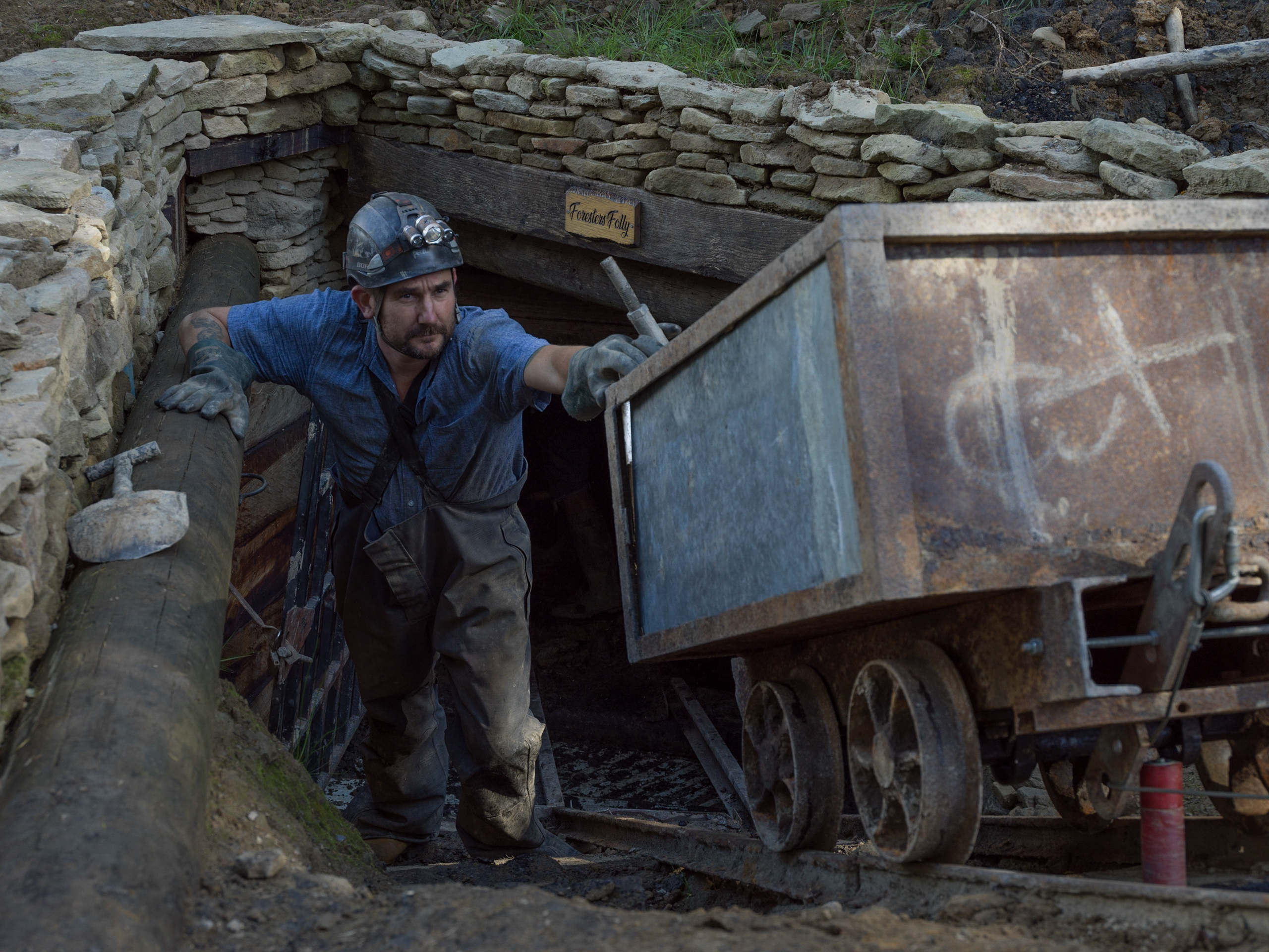 Miner exiting mine entrance