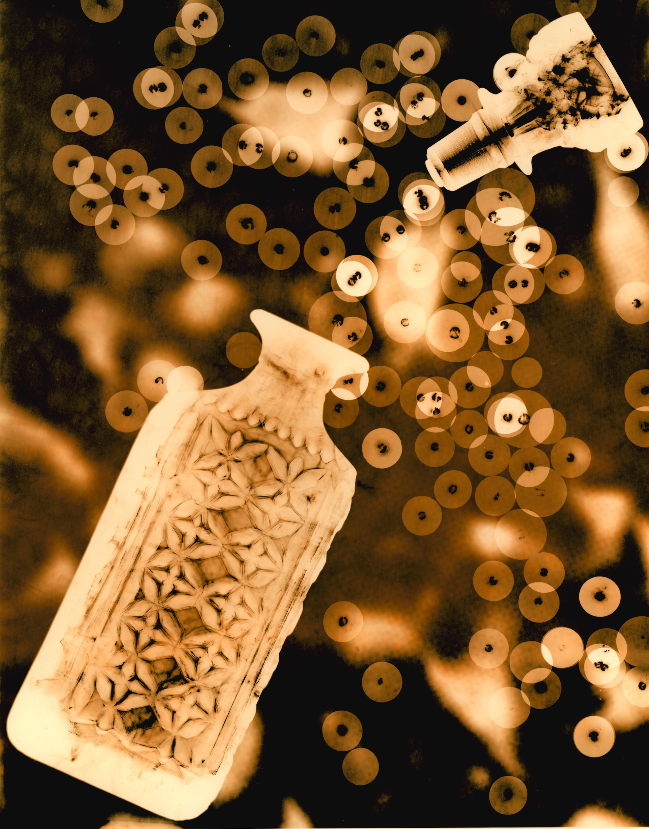 image of a glass decanter (pictures bottom left) with stopper at the top right surrounded by small circles. The background of the image contains a close up view of embryonic mucous connecting tissue