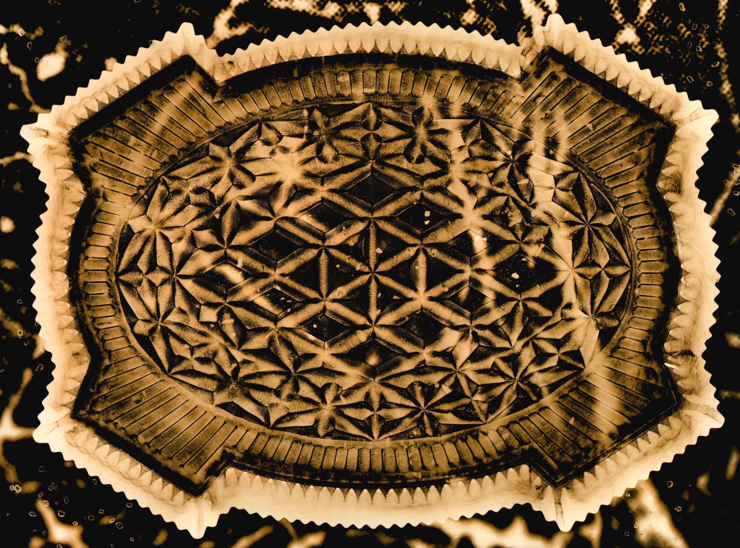 Image of a glass decorative dressing table tray. The background of the image contains a close up view of a motor neurone cell with grains of salt